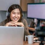 Asian business woman using technology laptop and working from home in home office