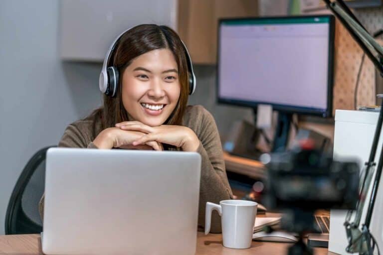 Asian business woman using technology laptop and working from home in home office