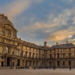 iew of famous Louvre Museum with Louvre Pyramid at evening