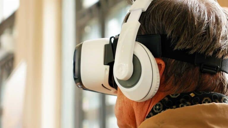 Senior old man wearing VR headset and enjoying virtual reality digital world